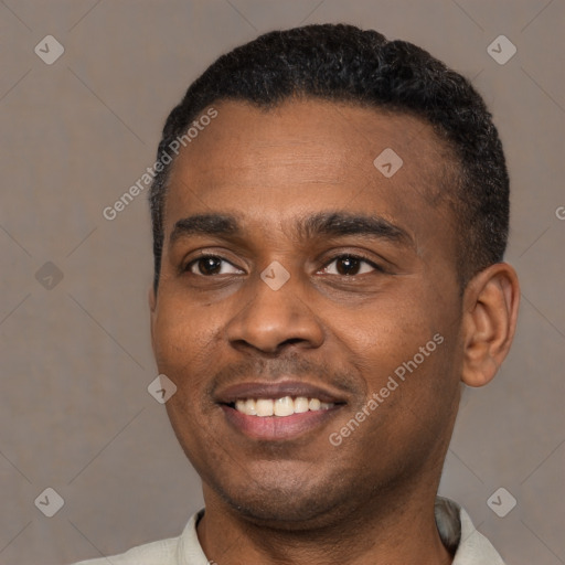 Joyful black young-adult male with short  black hair and brown eyes