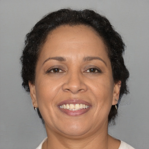 Joyful black adult female with short  brown hair and brown eyes