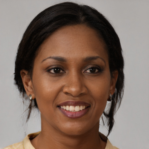 Joyful black young-adult female with medium  brown hair and brown eyes