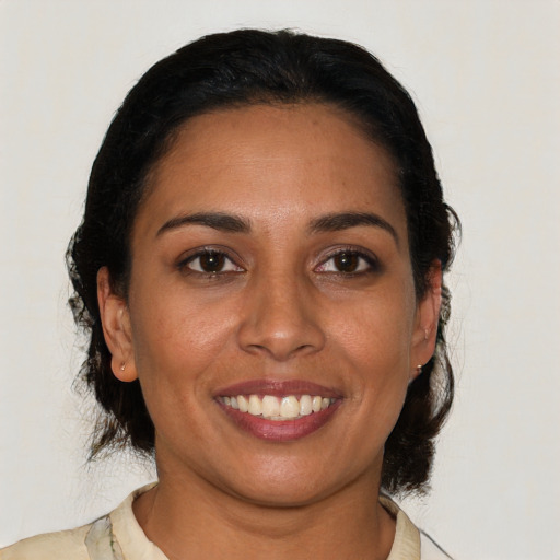 Joyful latino young-adult female with medium  brown hair and brown eyes