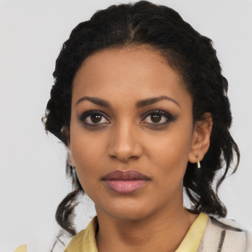 Joyful black young-adult female with medium  black hair and brown eyes