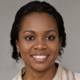 Joyful black young-adult female with medium  brown hair and brown eyes