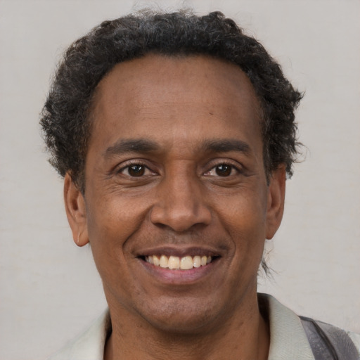 Joyful latino adult male with short  brown hair and brown eyes