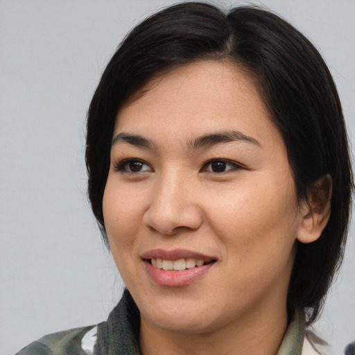 Joyful asian young-adult female with medium  brown hair and brown eyes
