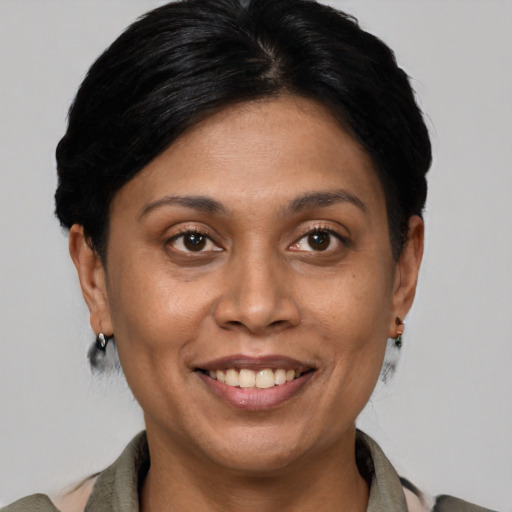 Joyful latino adult female with short  brown hair and brown eyes