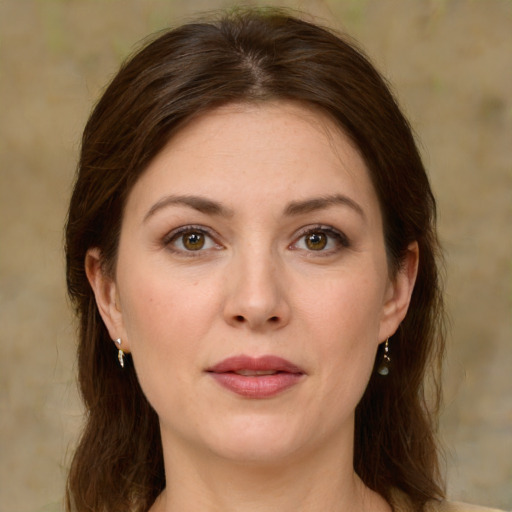 Joyful white young-adult female with medium  brown hair and green eyes