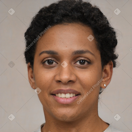 Joyful black young-adult female with short  black hair and brown eyes