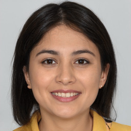 Joyful latino young-adult female with medium  brown hair and brown eyes