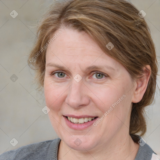 Joyful white adult female with medium  brown hair and blue eyes