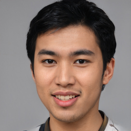 Joyful asian young-adult male with short  brown hair and brown eyes