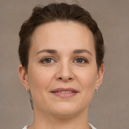 Joyful white young-adult female with short  brown hair and grey eyes