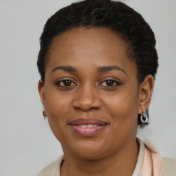 Joyful black young-adult female with short  brown hair and brown eyes
