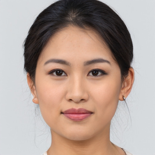 Joyful asian young-adult female with medium  brown hair and brown eyes