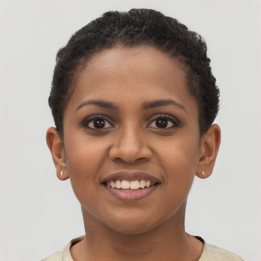 Joyful black young-adult female with short  brown hair and brown eyes