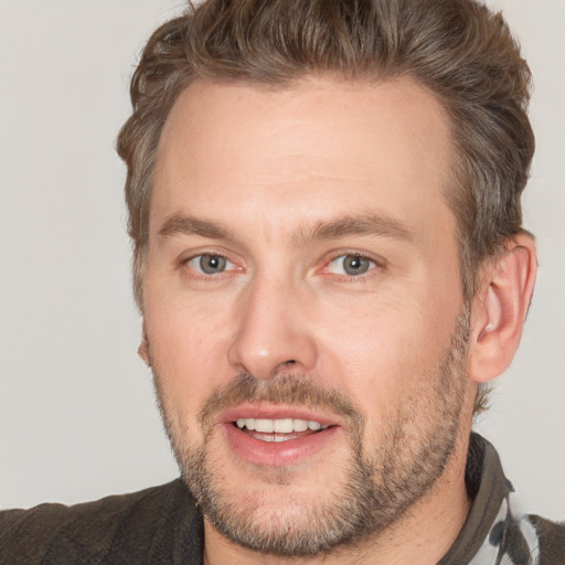 Joyful white adult male with short  brown hair and brown eyes