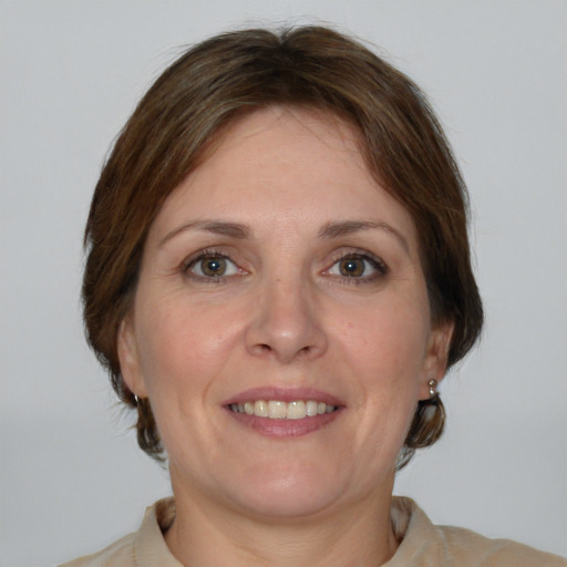 Joyful white adult female with medium  brown hair and grey eyes