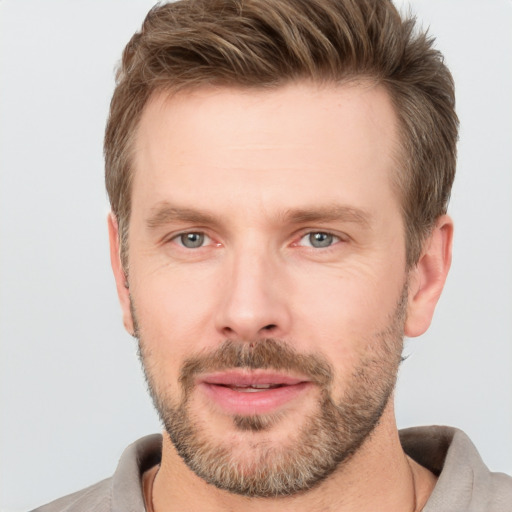 Joyful white adult male with short  brown hair and grey eyes