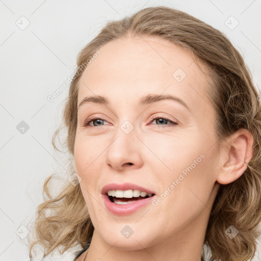 Joyful white young-adult female with medium  brown hair and blue eyes