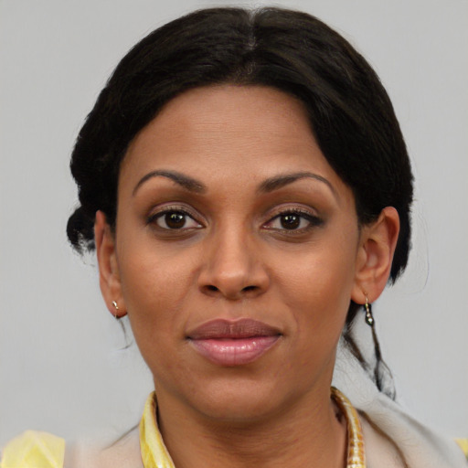 Joyful black young-adult female with short  brown hair and brown eyes