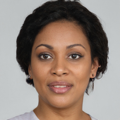 Joyful black young-adult female with medium  brown hair and brown eyes