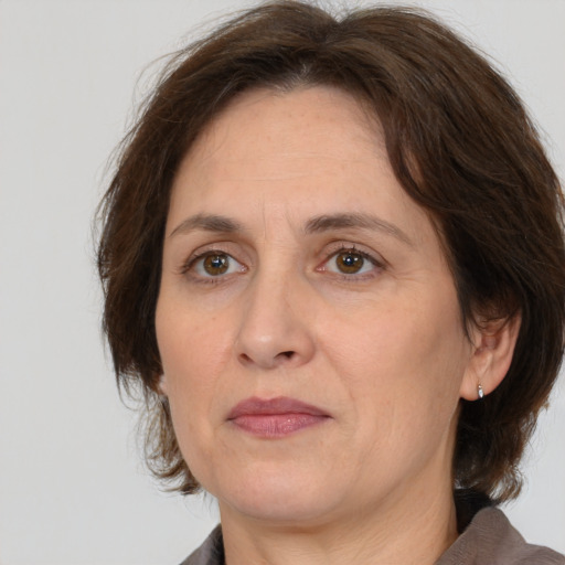 Joyful white adult female with medium  brown hair and brown eyes