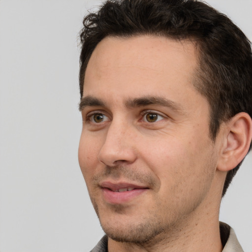 Joyful white young-adult male with short  brown hair and brown eyes