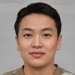 Joyful asian young-adult male with short  black hair and brown eyes