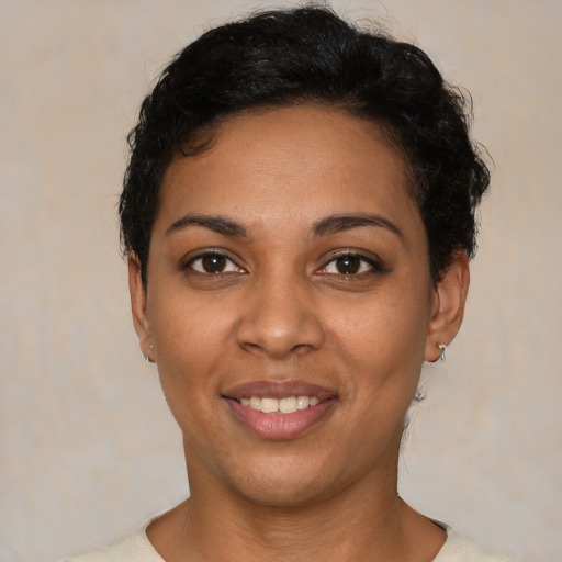 Joyful latino young-adult female with short  black hair and brown eyes
