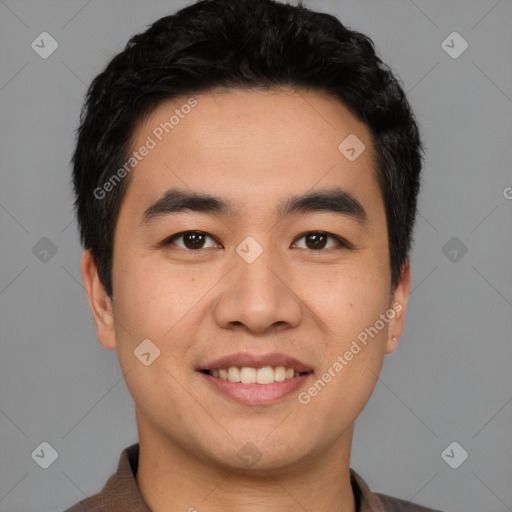 Joyful asian young-adult male with short  black hair and brown eyes