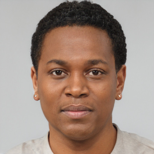 Joyful black young-adult male with short  brown hair and brown eyes