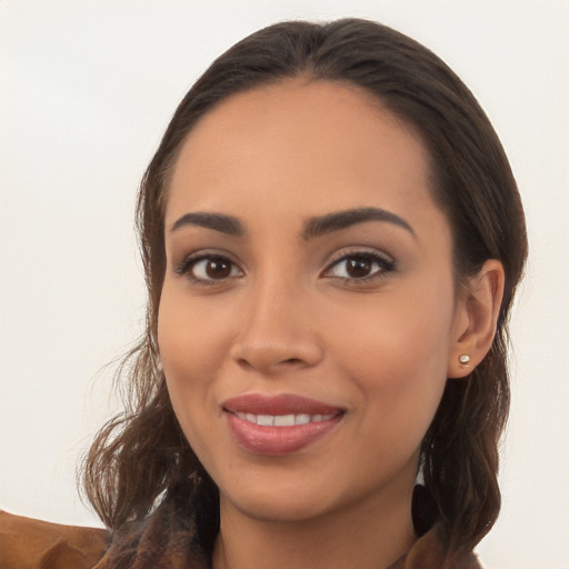 Joyful white young-adult female with long  brown hair and brown eyes