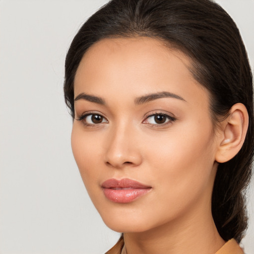 Joyful latino young-adult female with long  brown hair and brown eyes