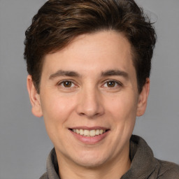 Joyful white adult male with short  brown hair and brown eyes