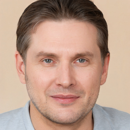 Joyful white adult male with short  brown hair and grey eyes