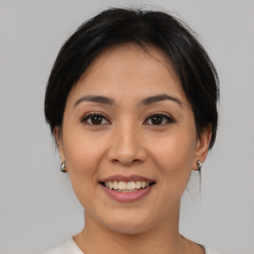 Joyful asian young-adult female with medium  brown hair and brown eyes