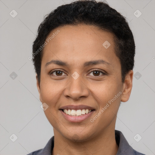 Joyful latino young-adult female with short  brown hair and brown eyes