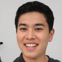 Joyful asian young-adult male with short  black hair and brown eyes