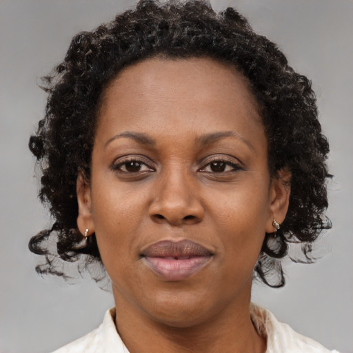 Joyful black adult female with short  brown hair and brown eyes