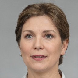 Joyful white adult female with medium  brown hair and grey eyes