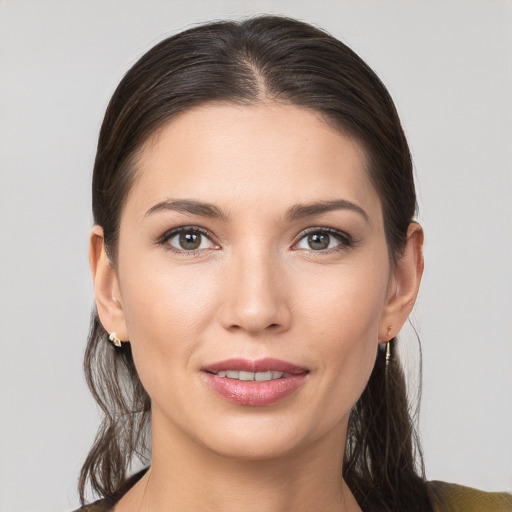 Joyful white young-adult female with medium  brown hair and brown eyes