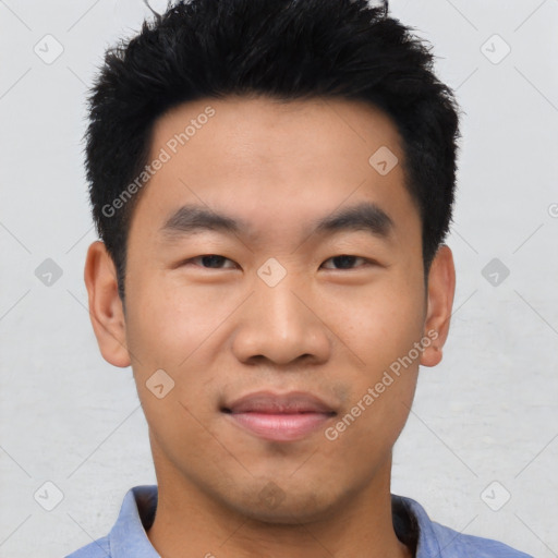 Joyful asian young-adult male with short  black hair and brown eyes