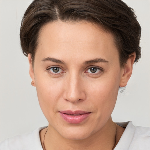 Joyful white young-adult female with short  brown hair and brown eyes