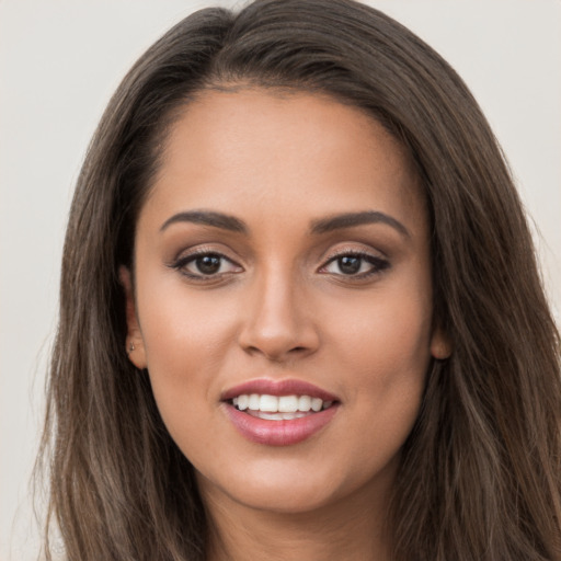 Joyful white young-adult female with long  brown hair and brown eyes