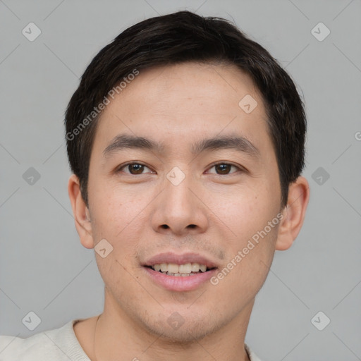 Joyful asian young-adult male with short  brown hair and brown eyes