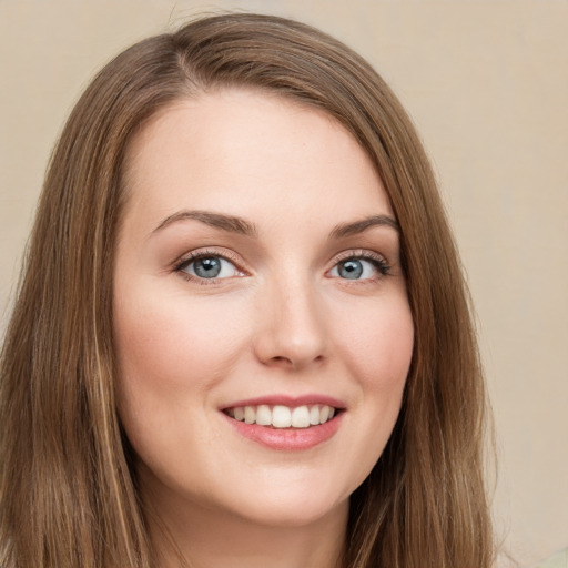 Joyful white young-adult female with long  brown hair and green eyes