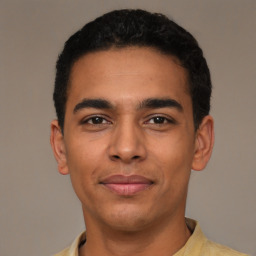 Joyful latino young-adult male with short  black hair and brown eyes