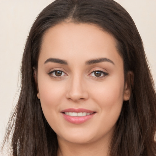 Joyful white young-adult female with long  brown hair and brown eyes