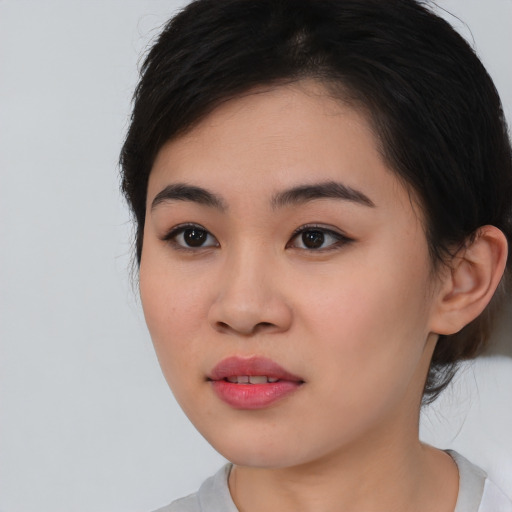 Joyful asian young-adult female with medium  black hair and brown eyes