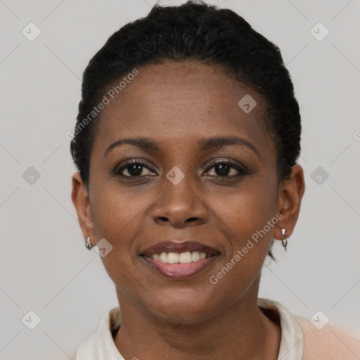 Joyful black young-adult female with short  black hair and brown eyes