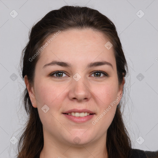 Joyful white young-adult female with long  brown hair and brown eyes